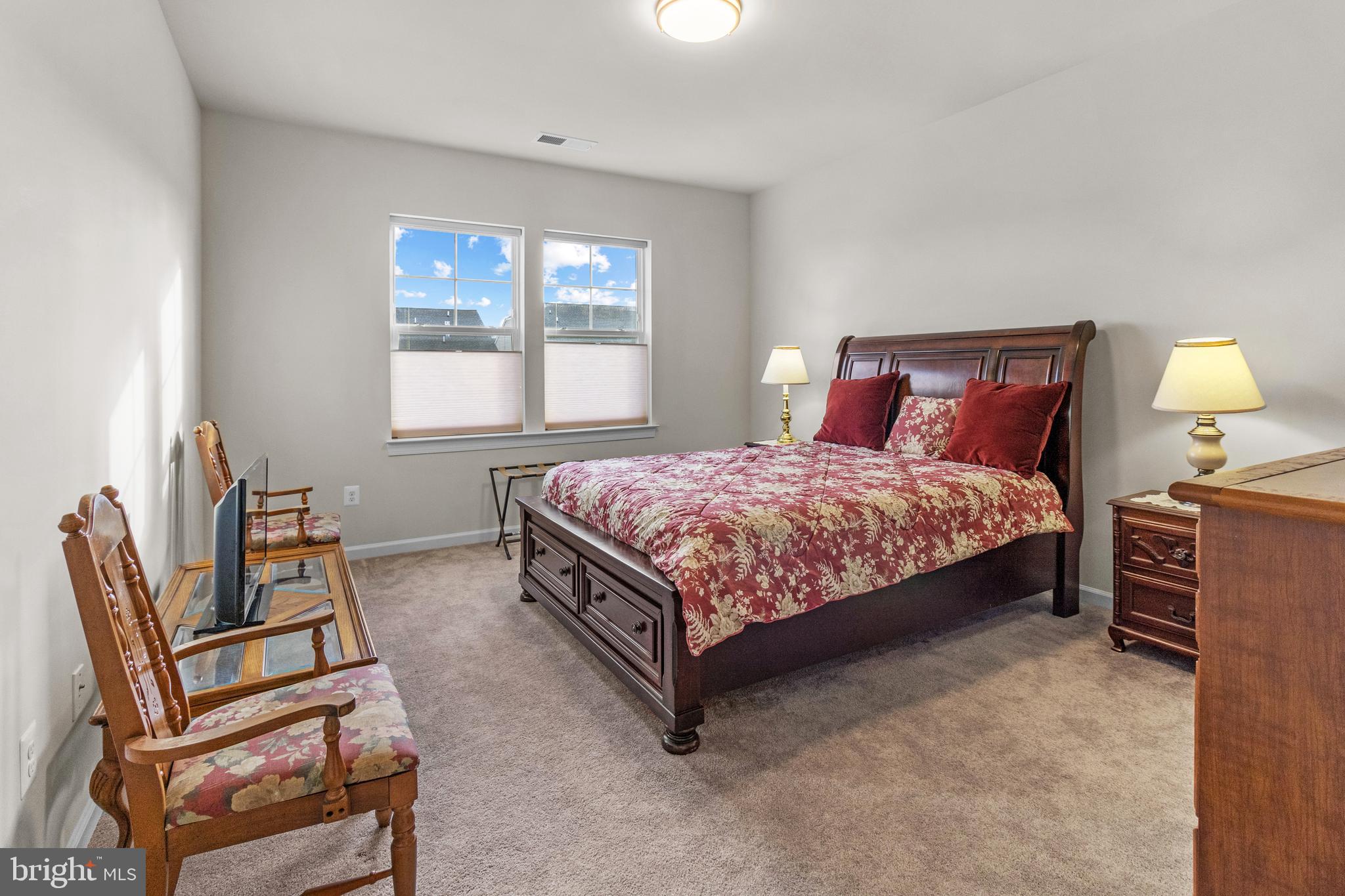 12129 American Chestnut Road Bowie, MD 20720 - Photo 12 of 25 a bed sitting in a bedroom next to a window