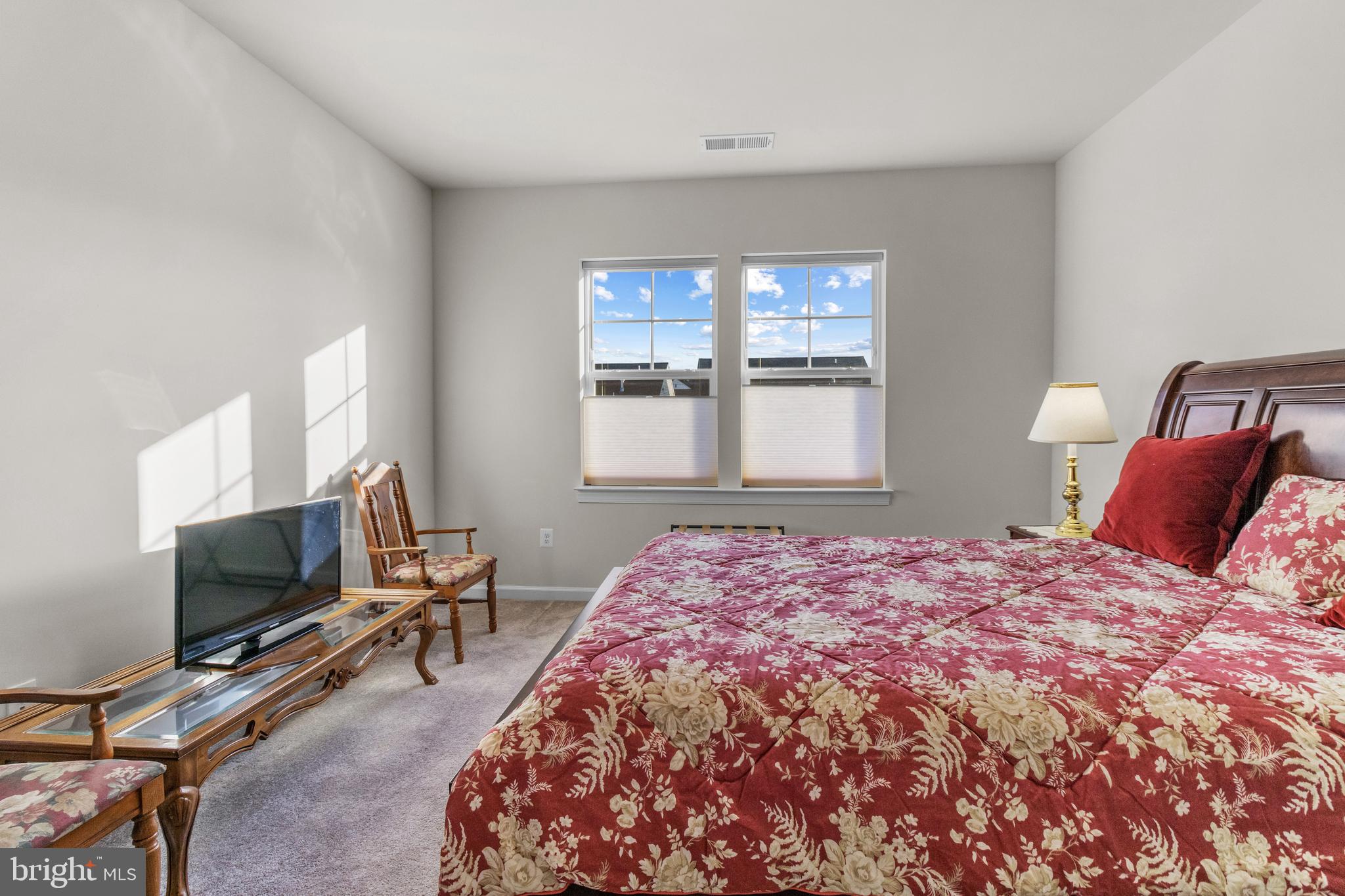 12129 American Chestnut Road Bowie, MD 20720 - Photo 13 of 25 a bedroom with a bed and a flat screen tv