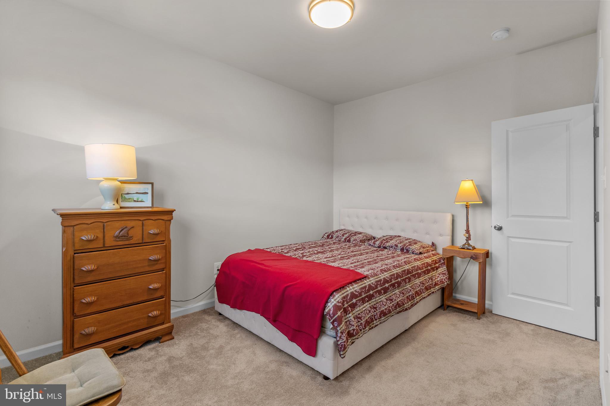 12129 American Chestnut Road Bowie, MD 20720 - Photo 19 of 25 a bedroom with a bed and lamp on desk