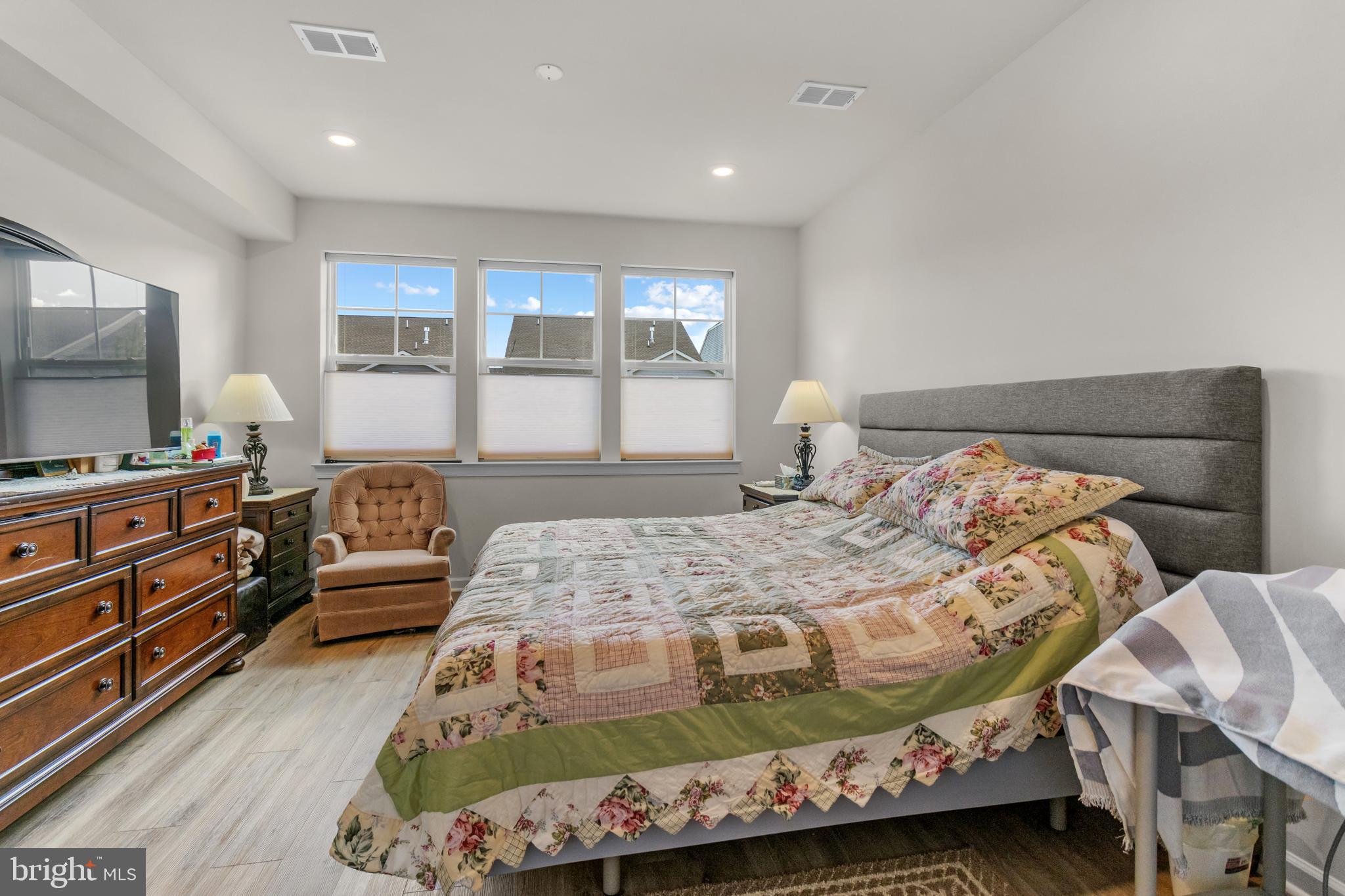 12129 American Chestnut Road Bowie, MD 20720 - Photo 20 of 25 a bedroom with a bed and flat screen tv