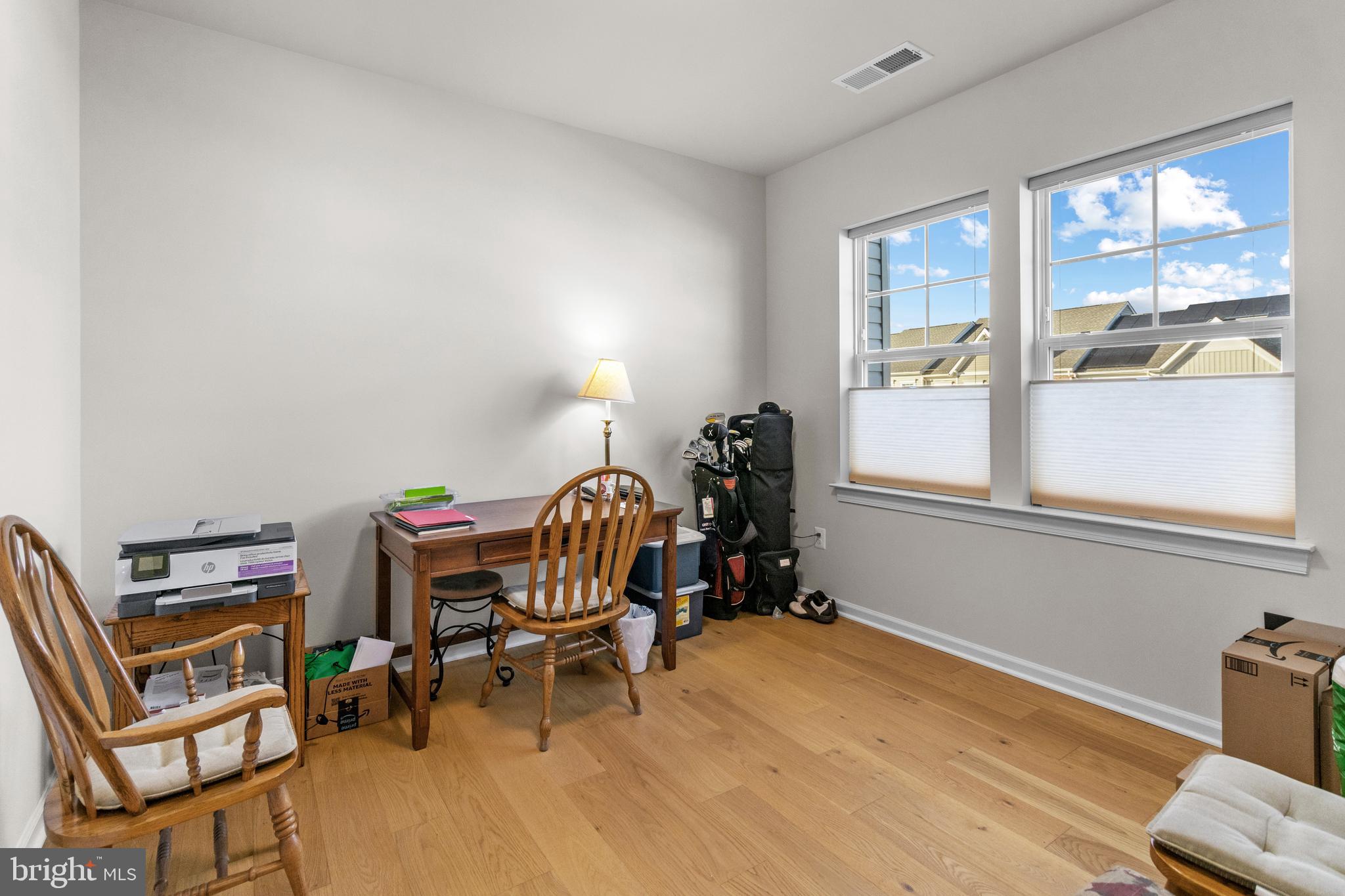 12129 American Chestnut Road Bowie, MD 20720 - Photo 22 of 25 a view of a workspace with furniture and a window