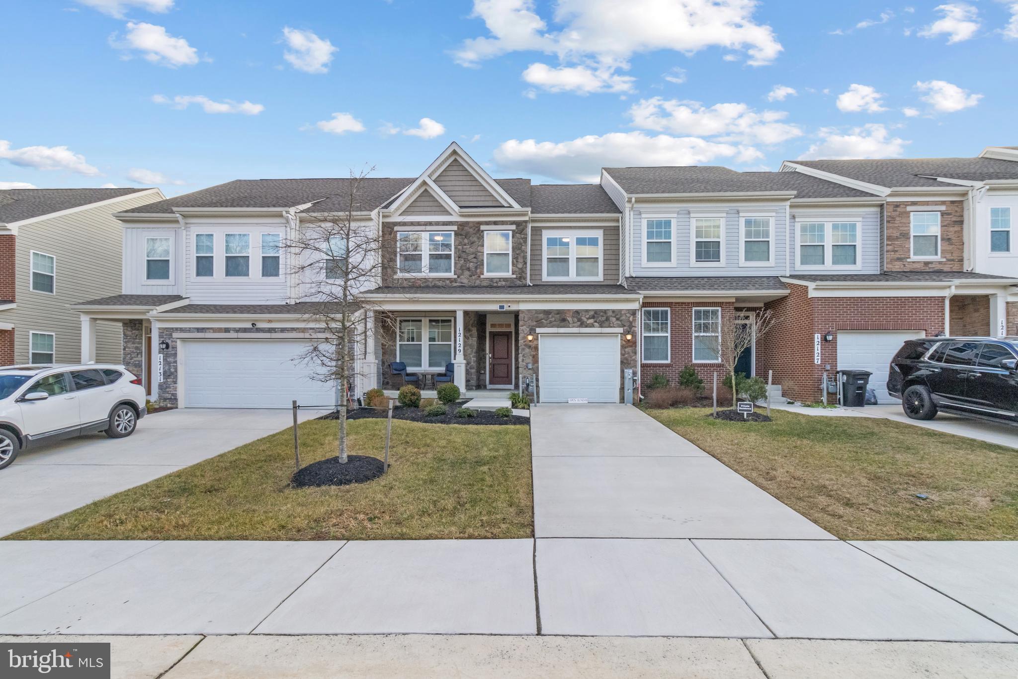 12129 American Chestnut Road Bowie, MD 20720 - Photo 25 of 25 a front view of a house with garden