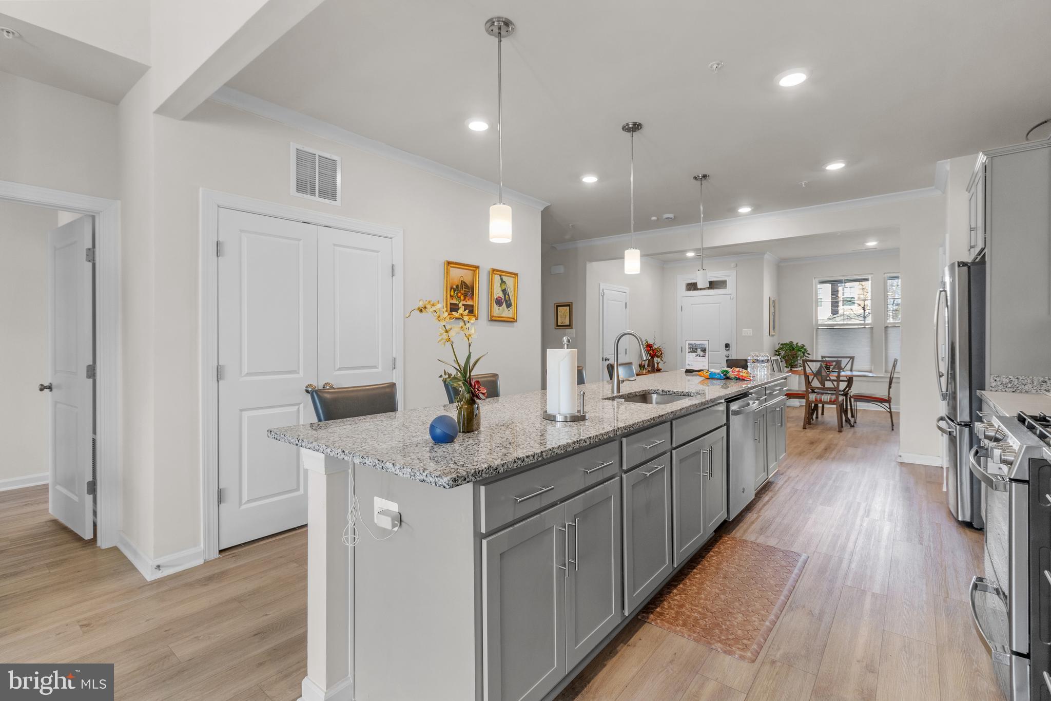 12129 American Chestnut Road Bowie, MD 20720 - Photo 7 of 25 a kitchen with stainless steel appliances granite countertop lots of counter top space and wooden floor
