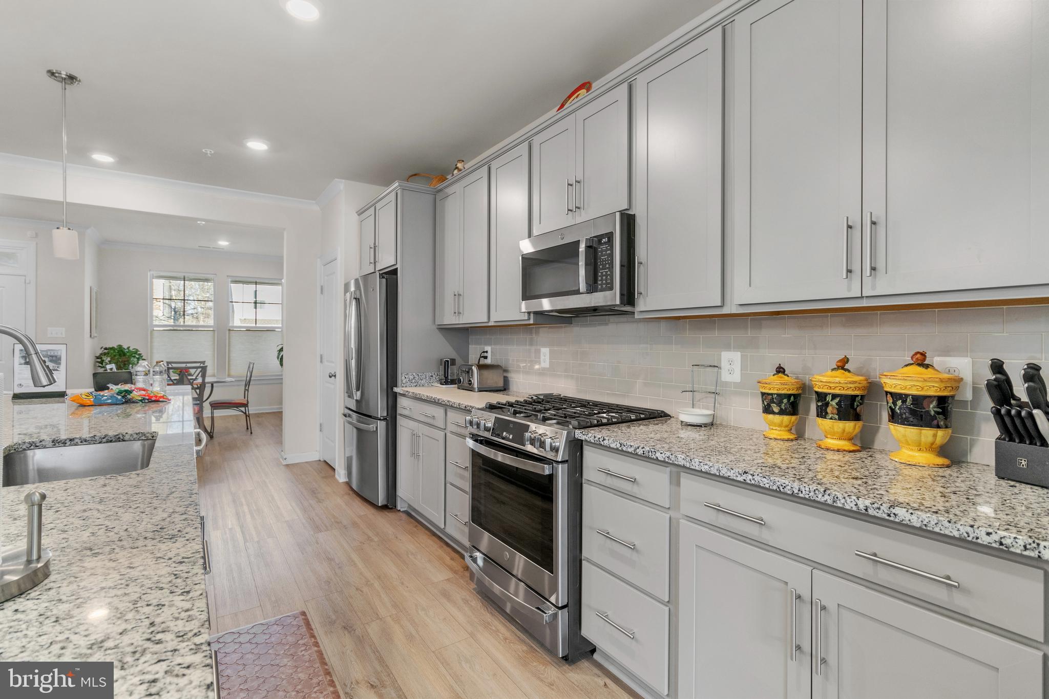 12129 American Chestnut Road Bowie, MD 20720 - Photo 8 of 25 a kitchen with stainless steel appliances granite countertop a stove a sink and a refrigerator