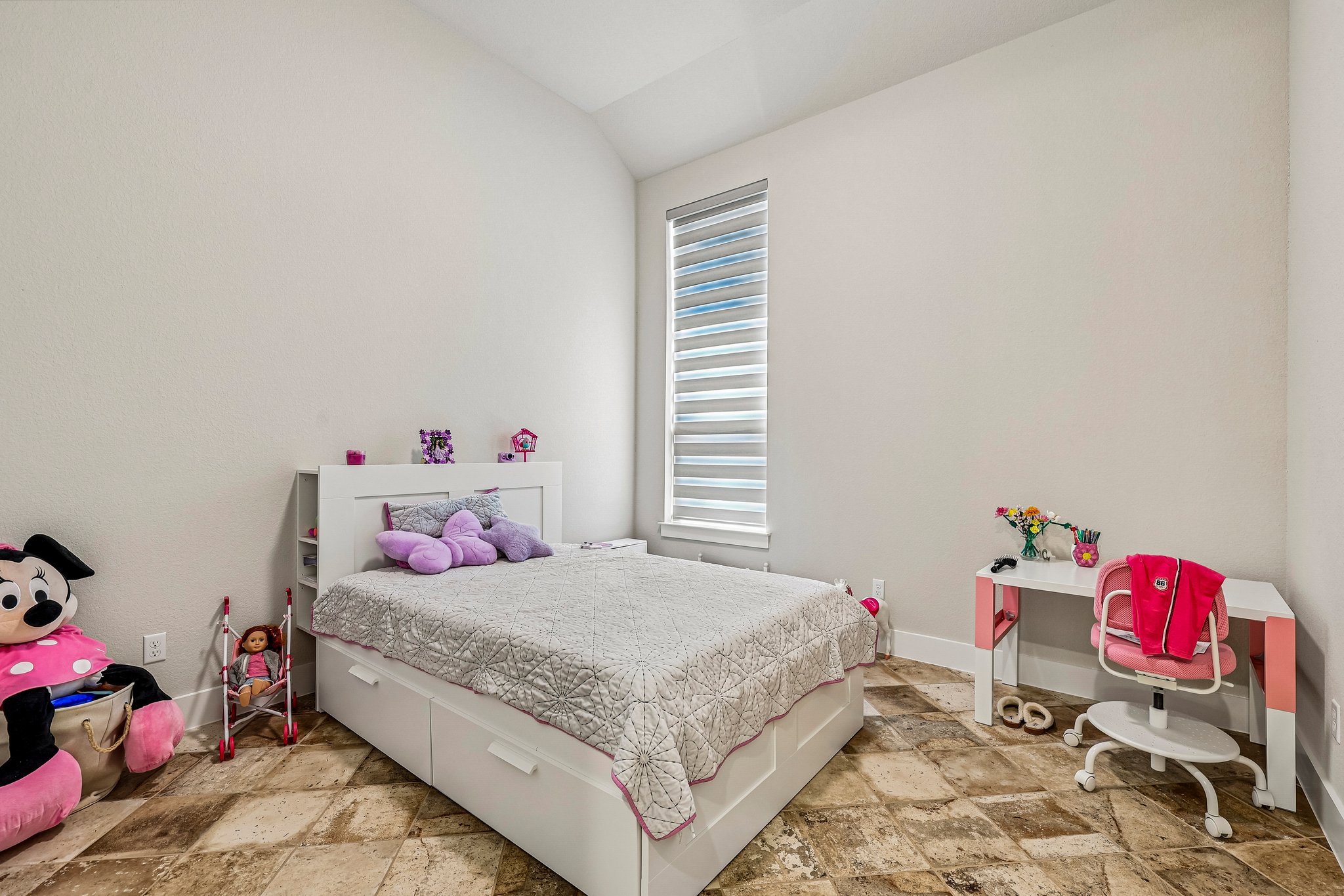 1705 Parten Rnch Parkway Austin, TX 78737 - Photo 17 of 39 A well-lit bedroom features vaulted ceilings and ample floor space on patterned tile flooring.