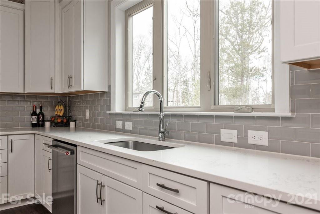 4000 Flowering Peach Road Marvin, NC 28173 - Photo 17 of 48 a kitchen with a sink and cabinets