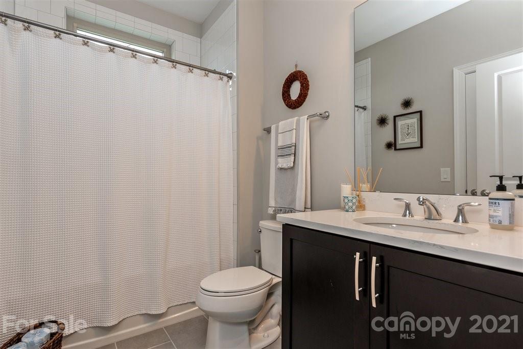4000 Flowering Peach Road Marvin, NC 28173 - Photo 19 of 48 a bathroom with a sink a toilet and a mirror
