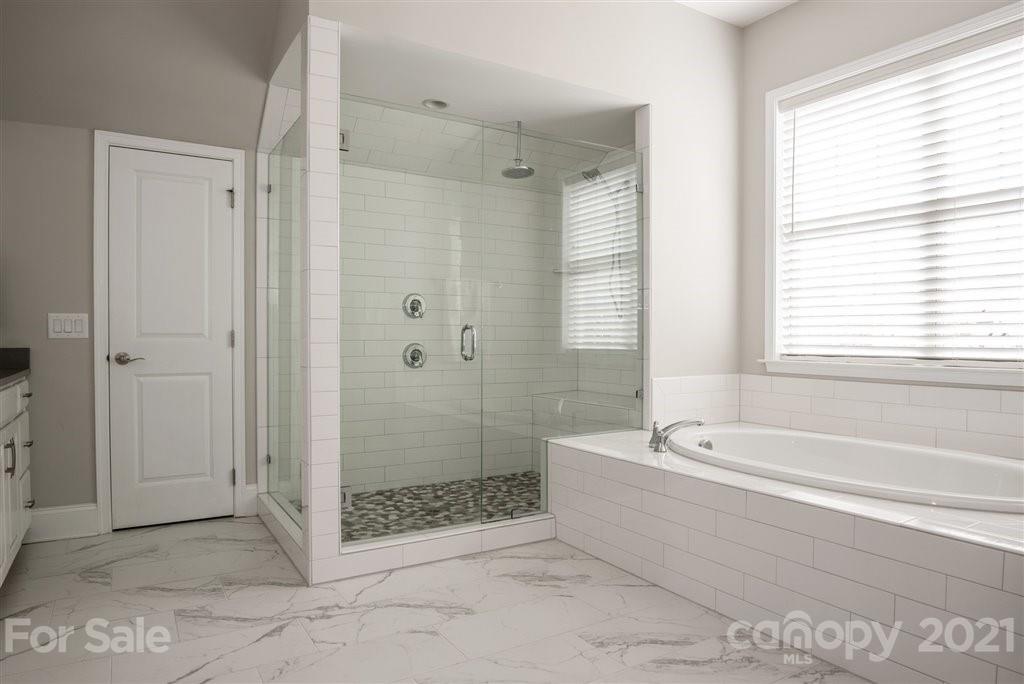 4000 Flowering Peach Road Marvin, NC 28173 - Photo 28 of 48 a bathroom with a bathtub and a shower