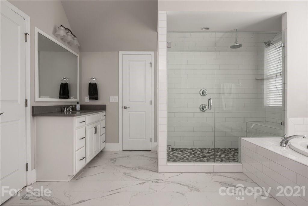 4000 Flowering Peach Road Marvin, NC 28173 - Photo 29 of 48 a bathroom with a shower sink and mirror