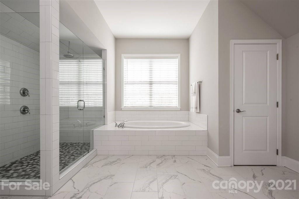 4000 Flowering Peach Road Marvin, NC 28173 - Photo 30 of 48 a spacious bathroom with a bathtub and a shower