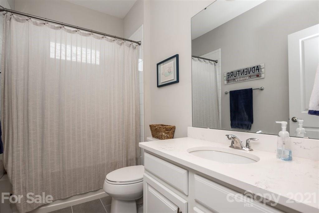 4000 Flowering Peach Road Marvin, NC 28173 - Photo 34 of 48 a bathroom with a granite countertop sink toilet and a mirror