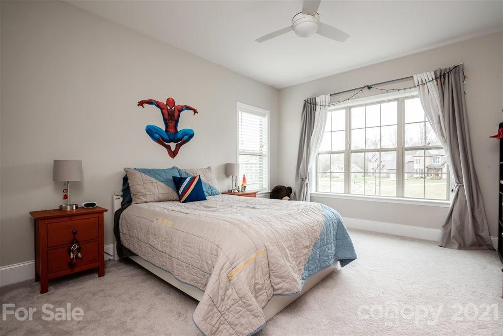 4000 Flowering Peach Road Marvin, NC 28173 - Photo 35 of 48 a bedroom with a bed and a chandelier