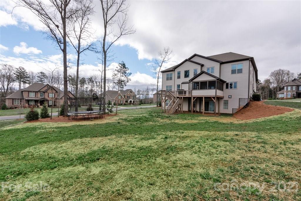 4000 Flowering Peach Road Marvin, NC 28173 - Photo 42 of 48 a view of a big house with a big yard and large trees
