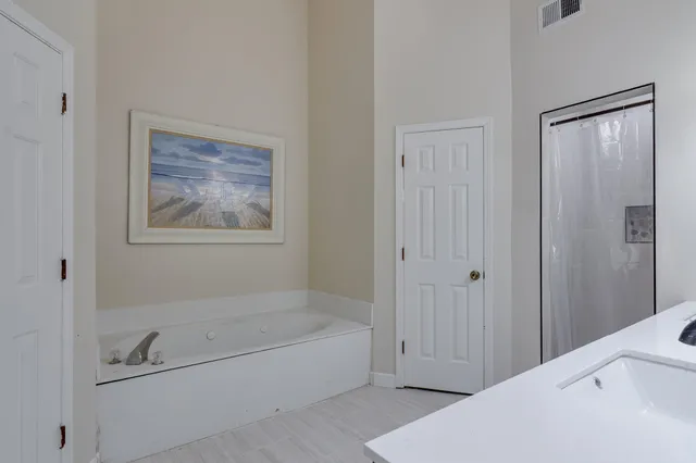 a bathroom with a tub and shower