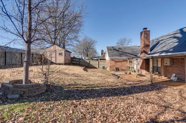 a view of a house with a yard covered in snow