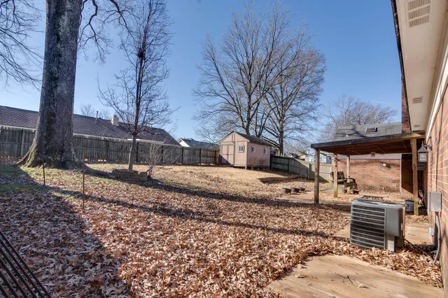 a view of a large white house with a yard covered with snow in front of house