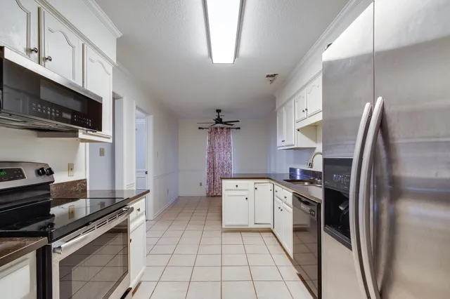 a kitchen with stainless steel appliances granite countertop a stove sink and refrigerator