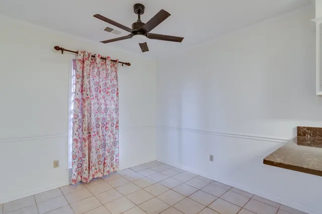 a view of a livingroom with a ceiling fan and a window