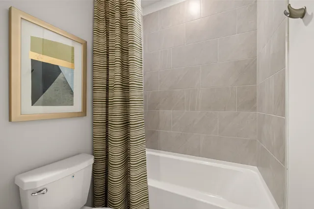 a en suite bathroom with a granite countertop sink and a mirror