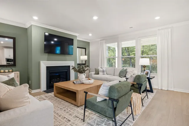 a living room with furniture a fireplace and a flat screen tv