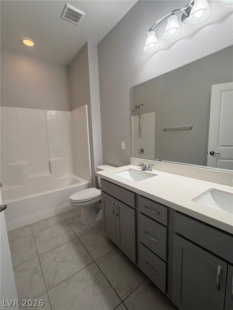 9953 Tucket Point Court Las Vegas, NV 89178 - Photo 19 of 22 Double vanity and a full shower-tub combination create a comfortable and functional space.