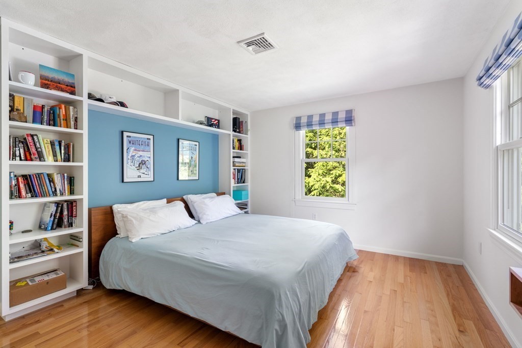 45 Upson Road Wellesley, MA 02482 - Photo 19 of 37 a bedroom with a bed and a book shelf