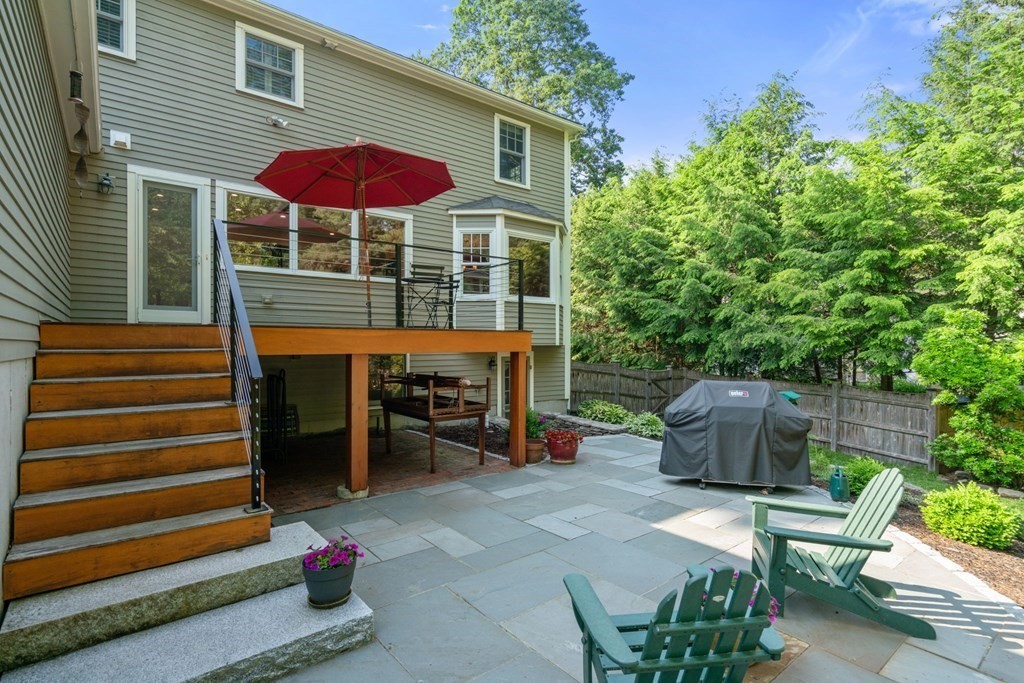 45 Upson Road Wellesley, MA 02482 - Photo 35 of 37 a view of a chairs and table in the back yard of the house
