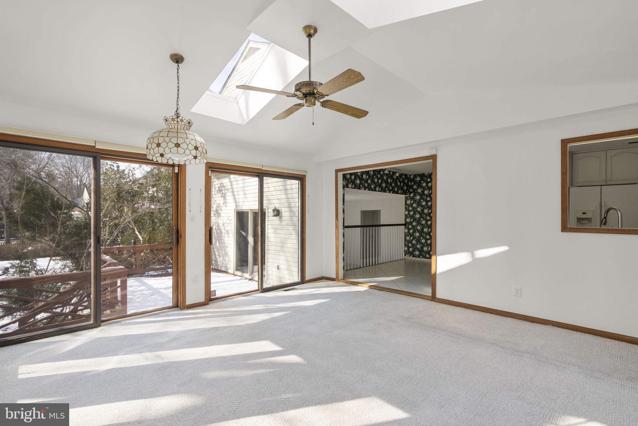 4404 Rendale Court Olney, MD 20832 - Photo 11 of 32 a view of a livingroom with a chandelier fan and windows