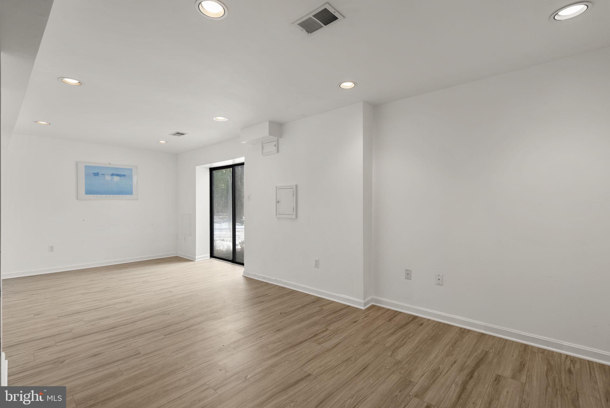 4404 Rendale Court Olney, MD 20832 - Photo 23 of 32 an empty room with wooden floor and windows