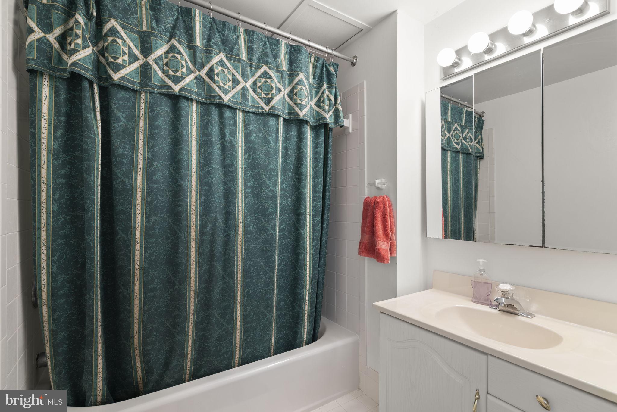 4404 Rendale Court Olney, MD 20832 - Photo 26 of 32 a bathroom with a sink vanity and a mirror