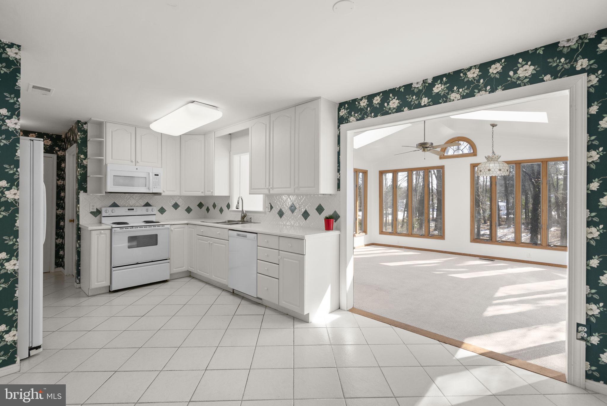 4404 Rendale Court Olney, MD 20832 - Photo 5 of 32 a kitchen with a white cabinets and white appliances