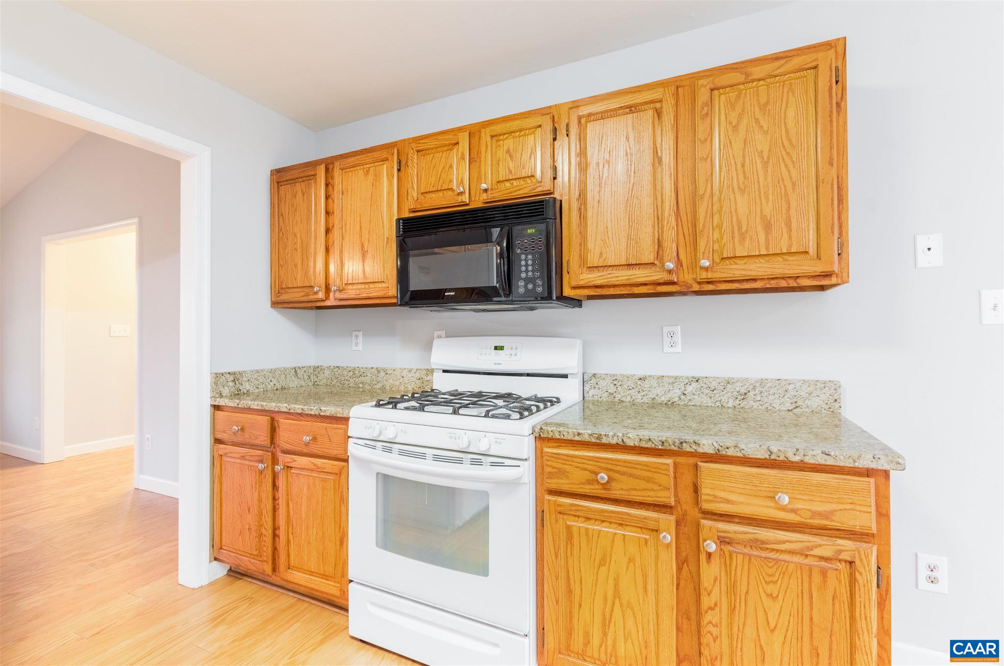 13 Brougham Road Palmyra, VA 22963 - Photo 14 of 38 a kitchen with granite countertop wooden cabinets stainless steel appliances and a counter space