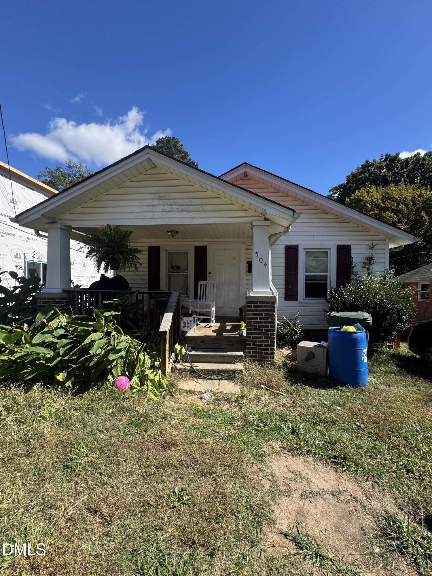a view of a house with backyard sitting area and garden