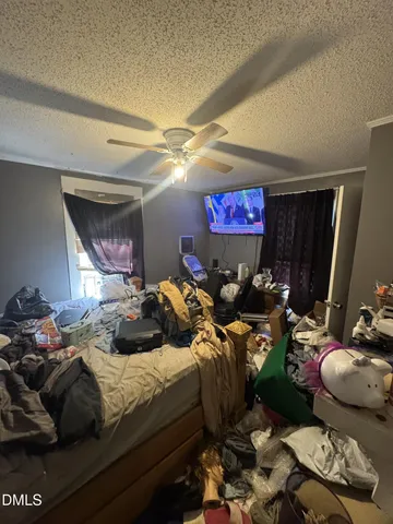 a bedroom with furniture and a flat screen tv