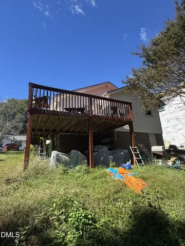 a view of a house with backyard porch and sitting area