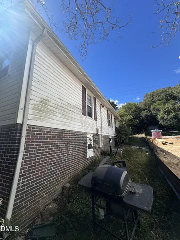 a view of a patio with table and chairs with wooden floor and fence