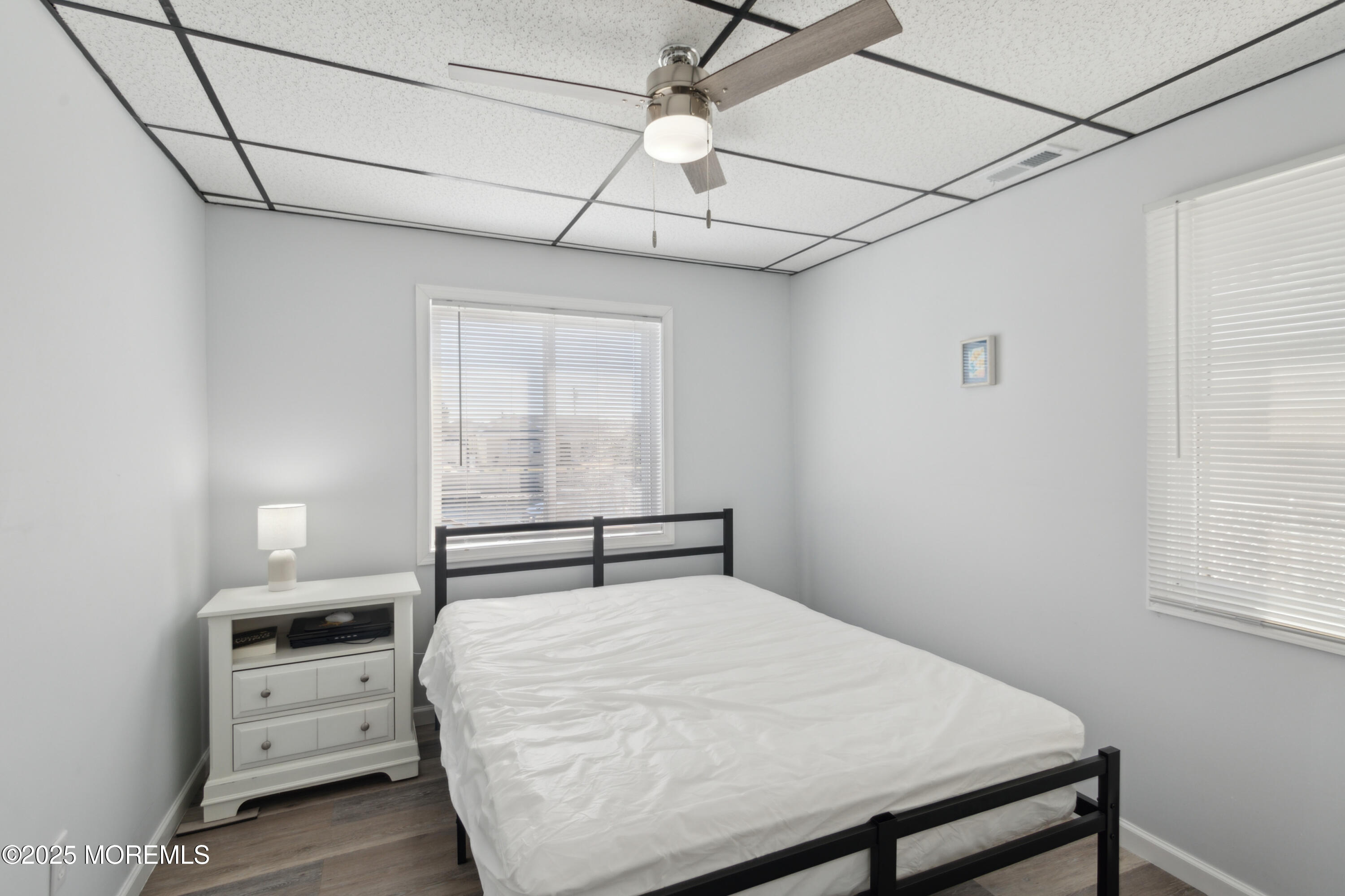 131 South Commodore Drive Little Egg Harbor, NJ 08087 - Photo 14 of 25 a bedroom with a bed a chandelier and a window