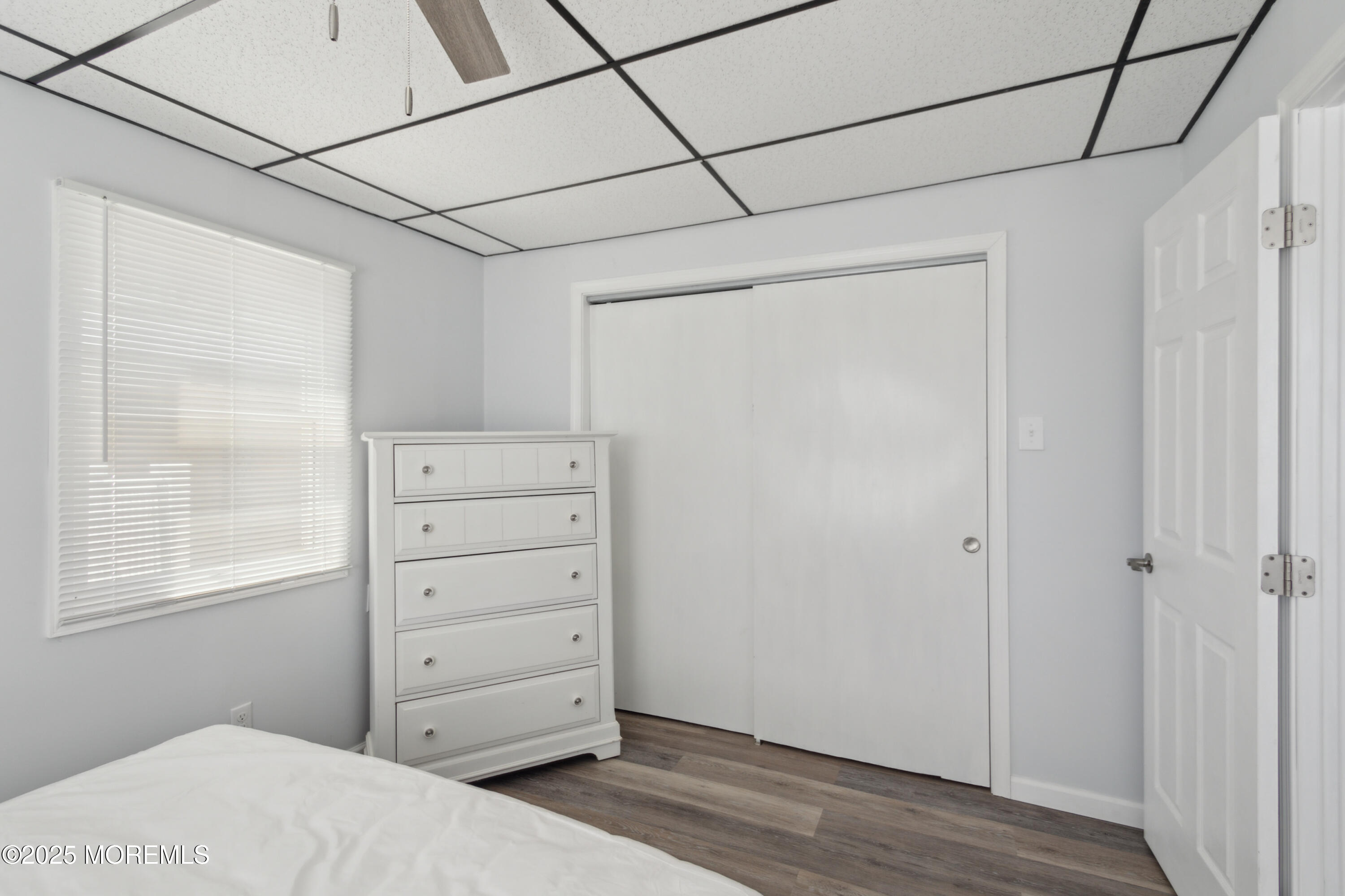 131 South Commodore Drive Little Egg Harbor, NJ 08087 - Photo 15 of 25 a bedroom with a wooden bed and a window