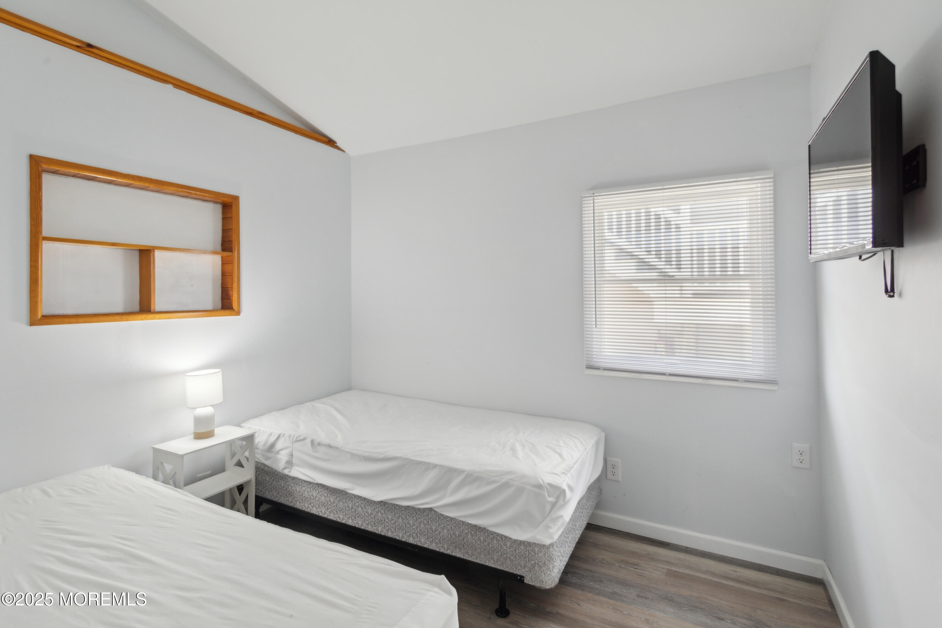 131 South Commodore Drive Little Egg Harbor, NJ 08087 - Photo 16 of 25 a bedroom with a bed and a flat screen tv