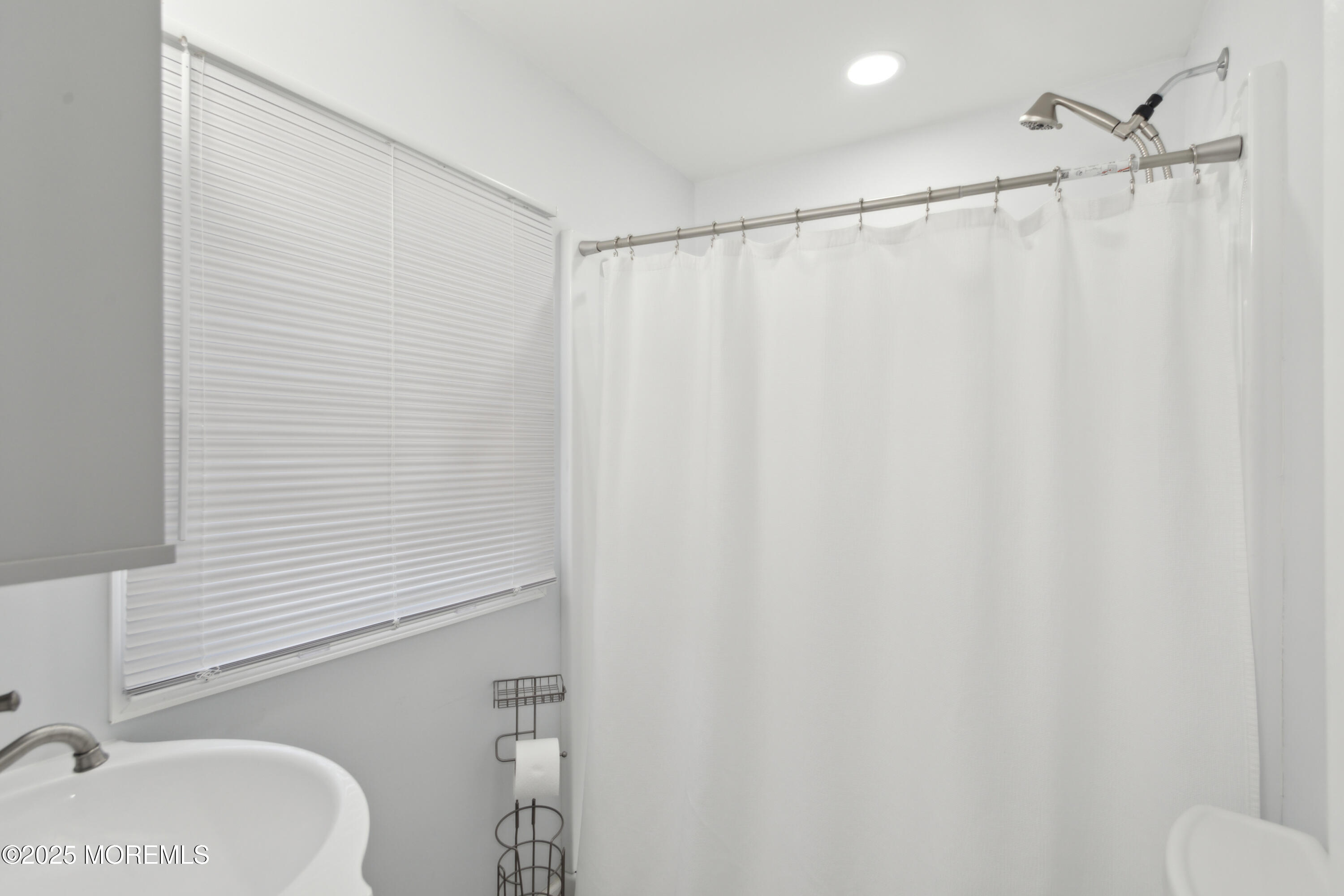 131 South Commodore Drive Little Egg Harbor, NJ 08087 - Photo 19 of 25 a bathroom with a shower curtain and a sink