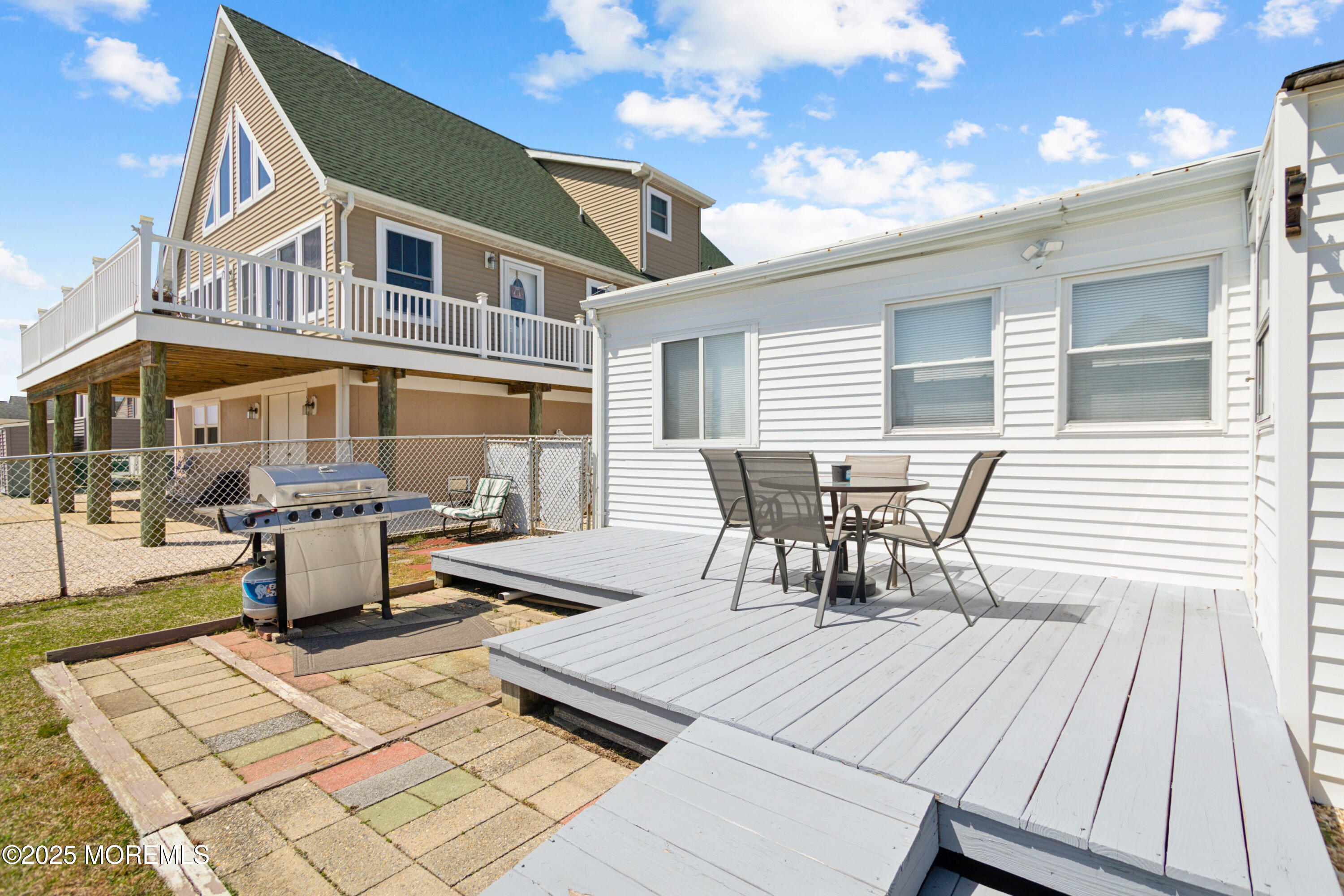 131 South Commodore Drive Little Egg Harbor, NJ 08087 - Photo 21 of 25 a roof deck with a dining table and chairs with wooden floor