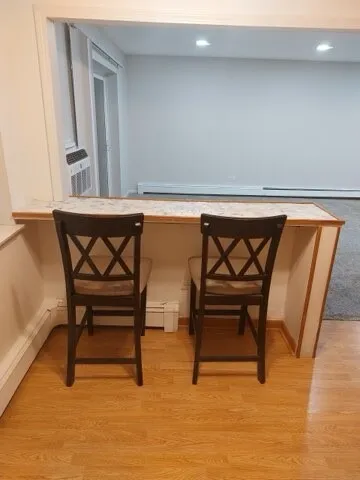 a view of chairs and table in a room