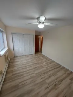 a view of a livingroom with wooden floor and staircase