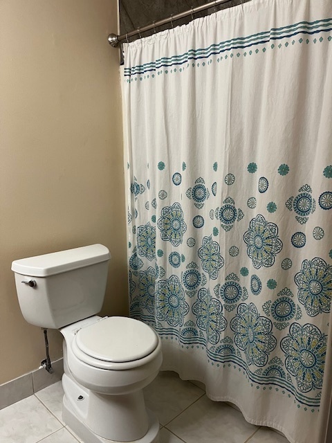1301 South Finley Road, Unit 414 Lombard, IL 60148 - Photo 14 of 25 a white toilet sitting next to a shower curtain
