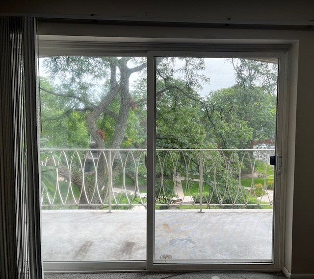 1301 South Finley Road, Unit 414 Lombard, IL 60148 - Photo 19 of 25 a view of a room with a large window and wooden floor
