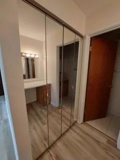 a view of walk in closet with empty racks