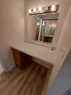 a bathroom with a granite countertop toilet and a sink