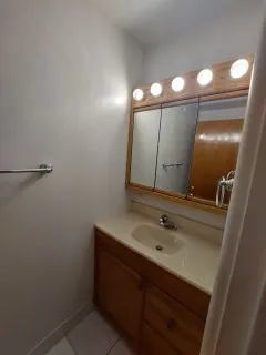 a view of a room with a large window and wooden floor