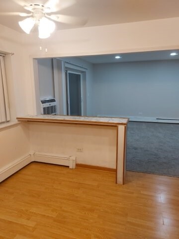 1301 South Finley Road, Unit 414 Lombard, IL 60148 - Photo 10 of 25 a view of room with window and wooden floor
