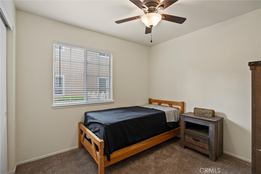 2055 Amanda Way, Unit 29 Chico, CA 95928 - Photo 16 of 19 a bedroom with a bed and a ceiling fan